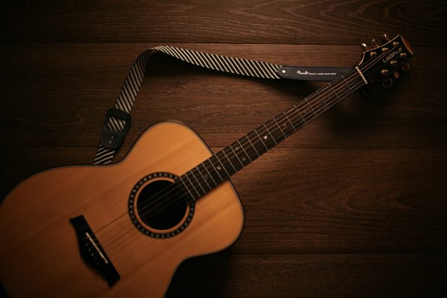 Acoustic Guitar Laying On Wood Floor