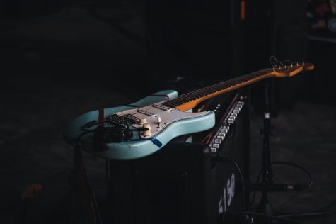 Fender Stratocaster lying on amplifier